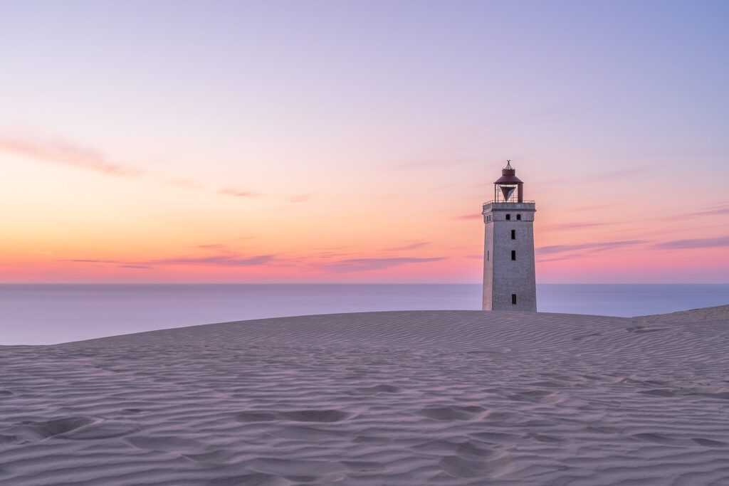 A lighthouse on the coast, symbolising discernment when choosing energy healing near you with Ad Unum