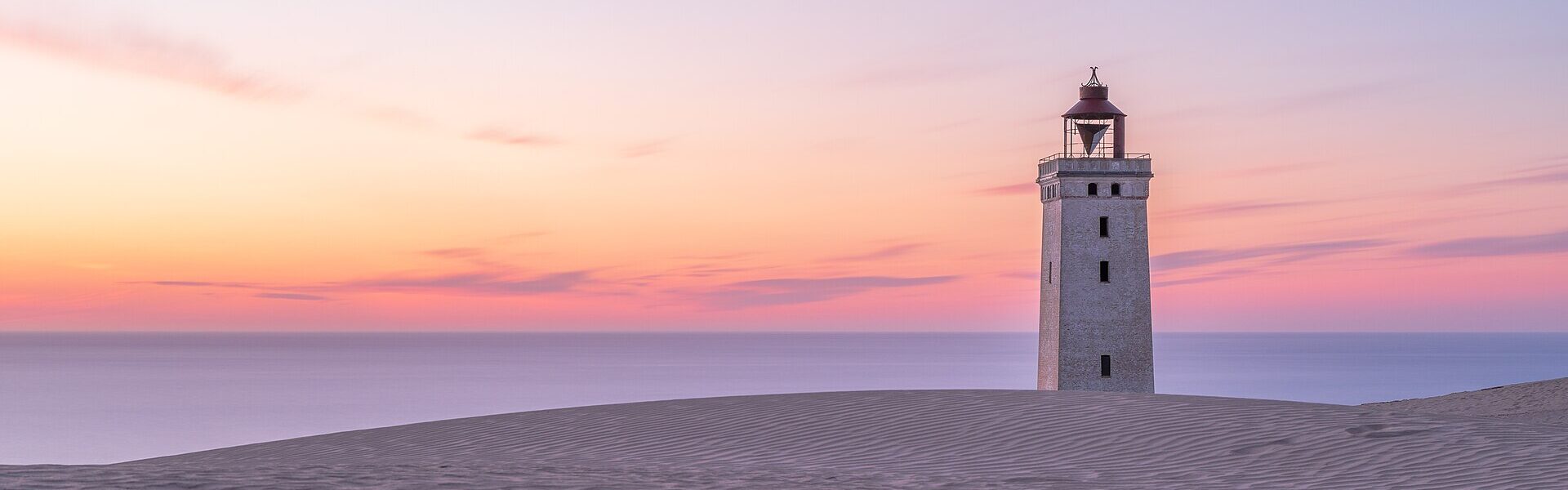 A lighthouse on the coast, symbolising discernment when choosing energy healing near you with Ad Unum