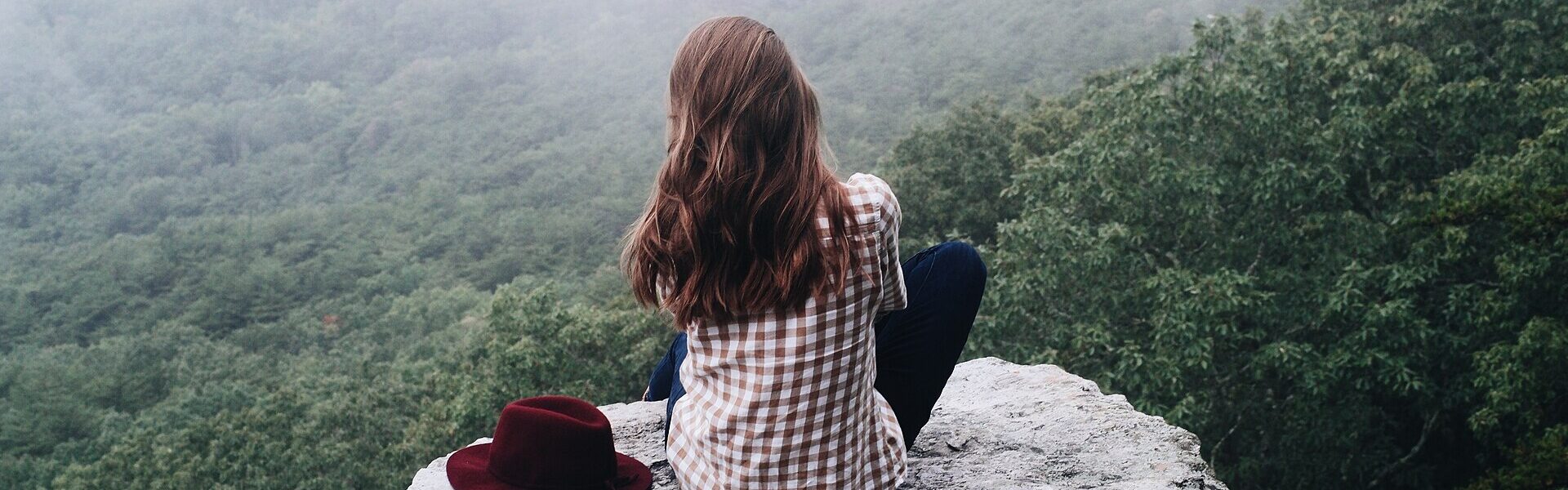 A person meditating in nature, contrasting meditation with Ad Unum Energy Healing
