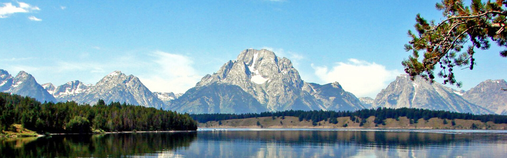 Still lake at dawn reflecting a mountain, an image of the observer and the observed