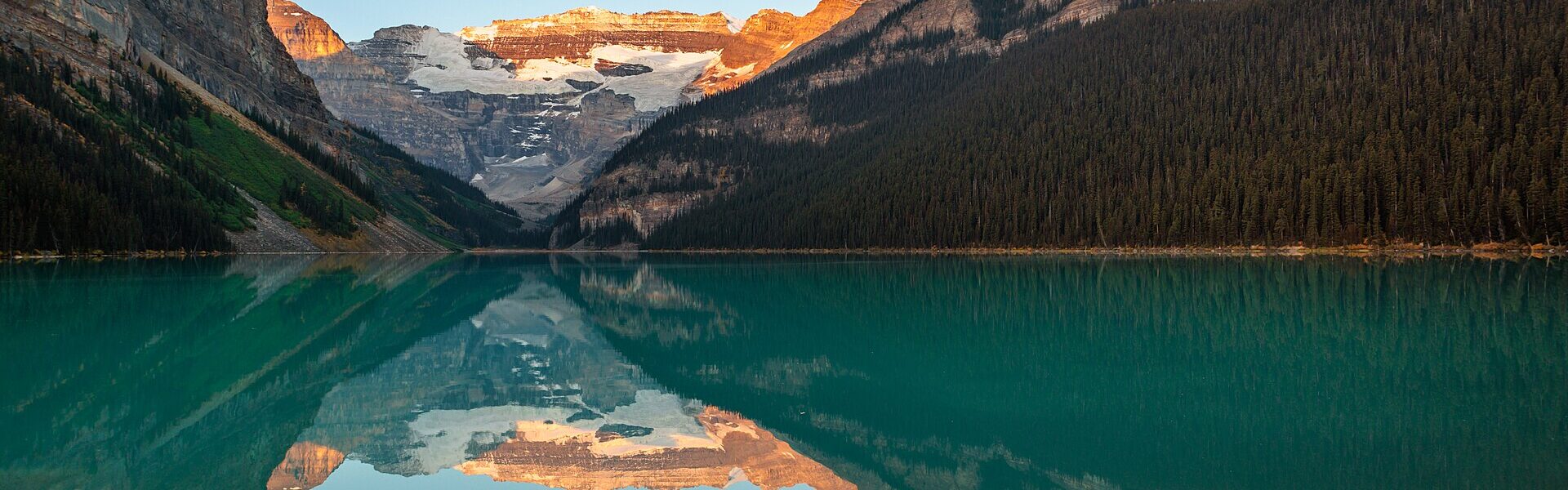 A still mountain lake at dawn, a model for inner balance and resilience in Ad Unum Energy Healing