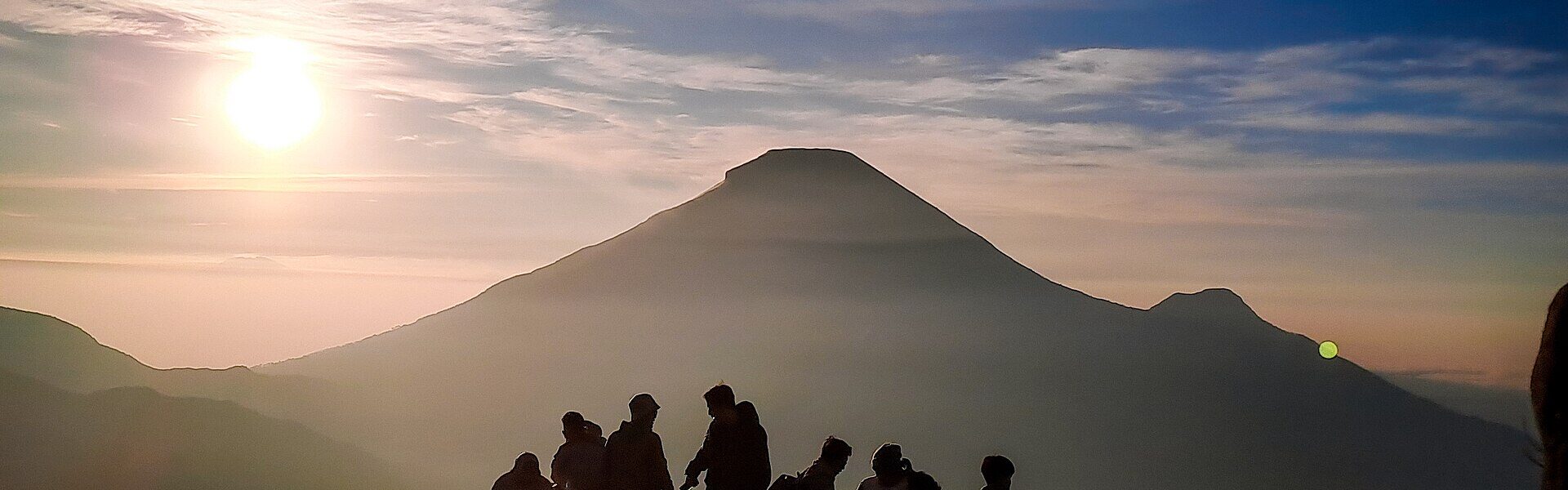 A silhouette at sunrise, reflecting on the signs of a natural helper in Ad Unum Energy Healing